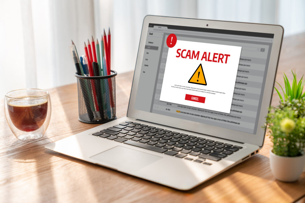 Laptop email inbox showing a “Scam Alert” warning