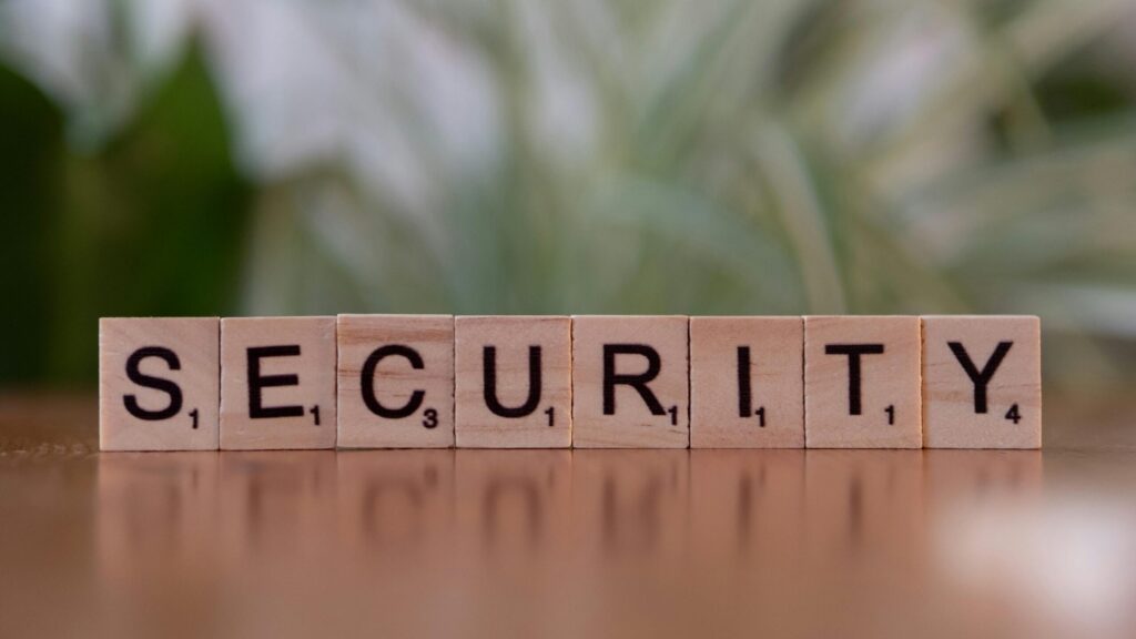 Wooden letter tiles spelling “SECURITY” on a table