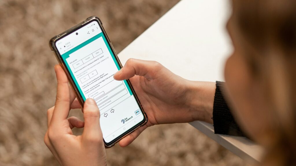 Person taking an online quiz on their phone, symbolizing how small online actions can expose private data.
