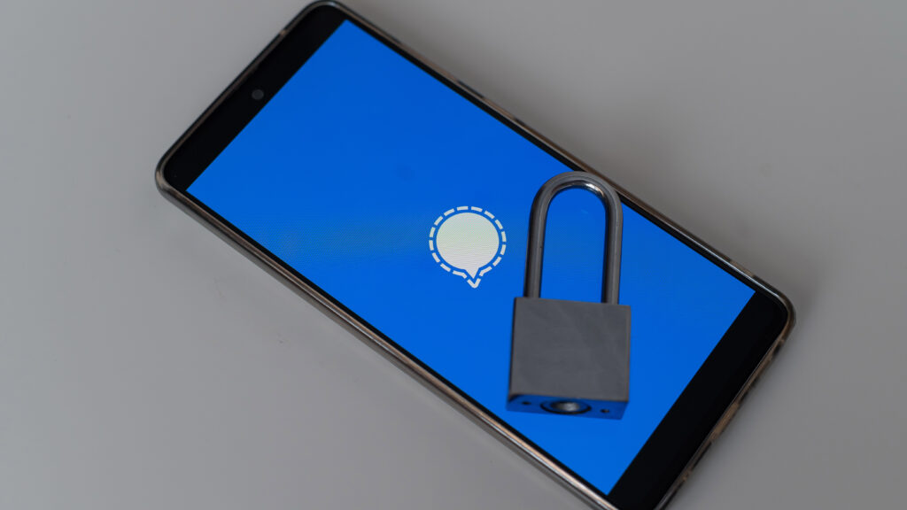 Smartphone displaying a messaging app icon with a padlock, symbolizing privacy, encryption, and messaging security risks.