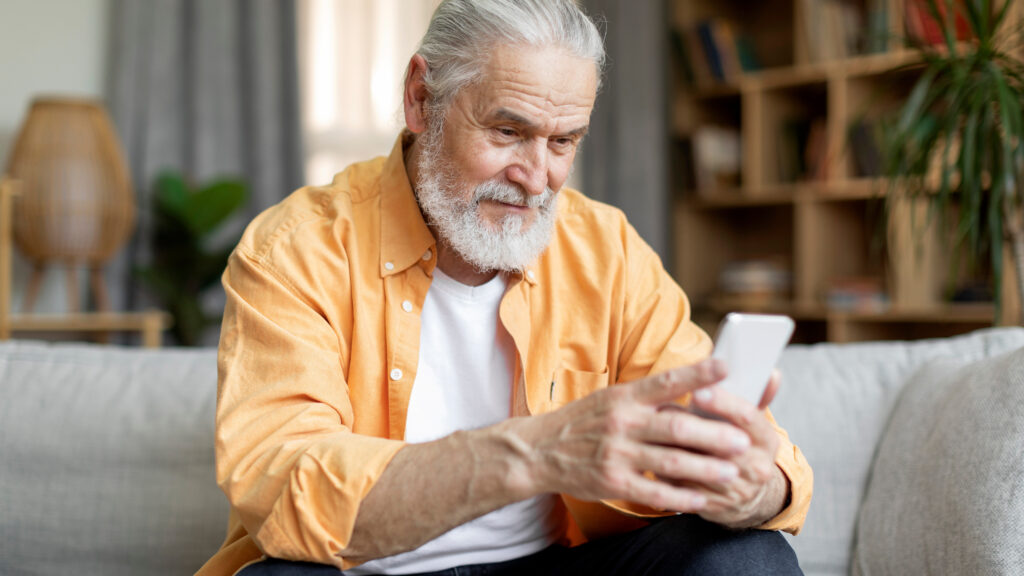 Senior receiving a phone call linked to a gold scam targeting older adults and their savings