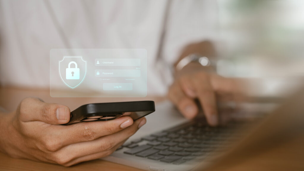 User logging into an account on phone and laptop after creating a strong password and enabling MFA