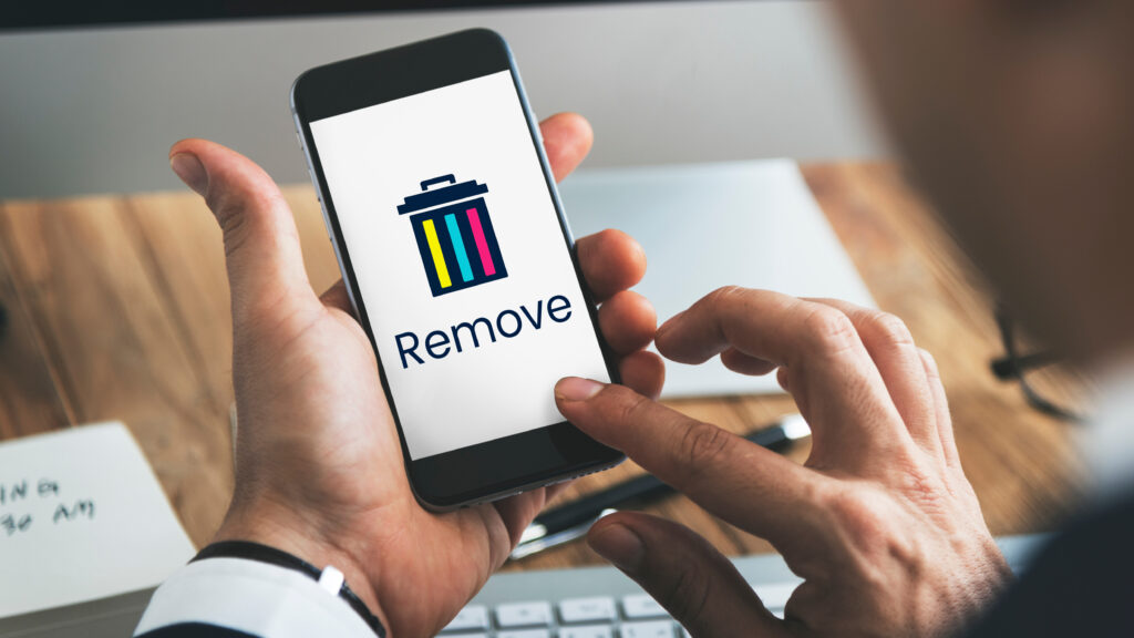 Person tapping a “Remove” option on a smartphone, representing the process of deleting old online accounts