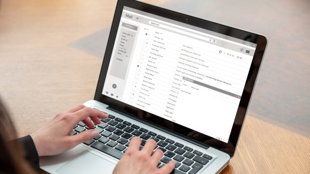 Person using email on a laptop, illustrating how phishing messages can appear during data breach scams