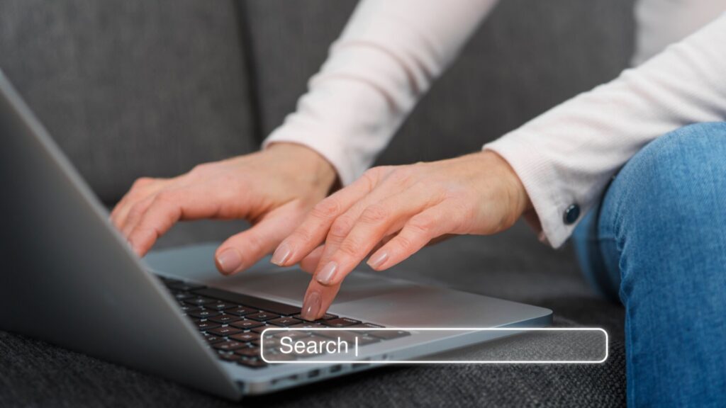 Person typing on laptop searching online to check if a deal is legitimate