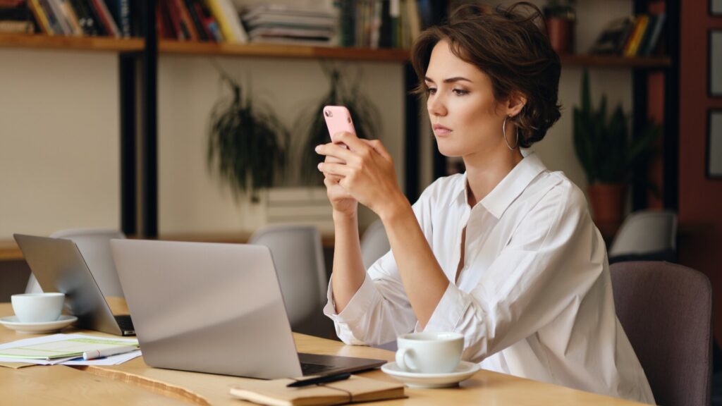 Woman securing her accounts on her phone after using a fake CAPTCHA website