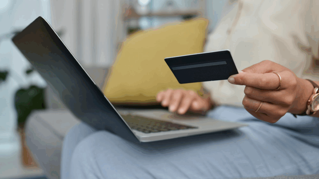 Person making an online donation with a credit card while reviewing a charity website