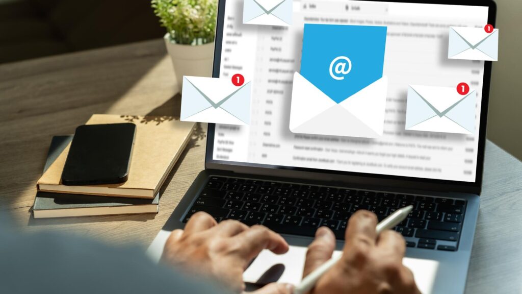 Person checking email messages on a laptop while reviewing account security.