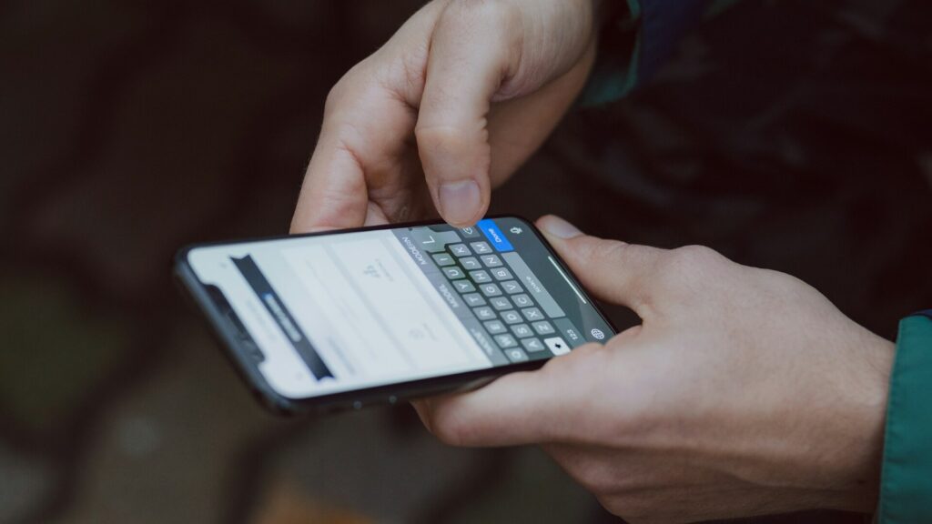 Person checking a message on a smartphone after a travel booking data leak