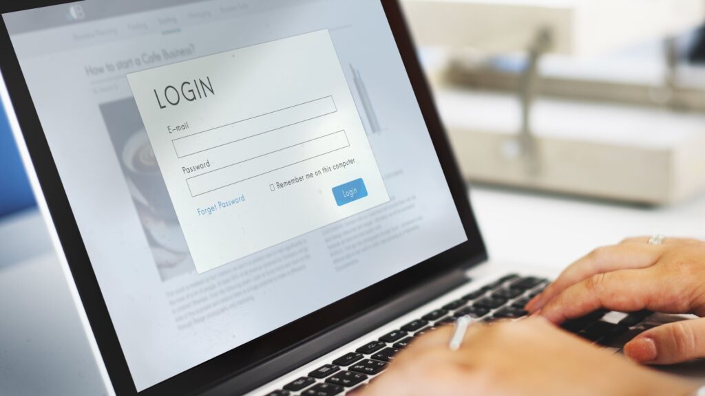 User logging into an online account on a laptop