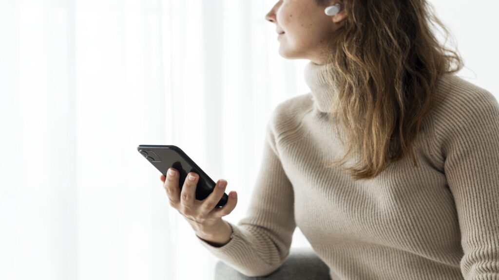 Woman using smartphone and ignoring unknown spam calls.