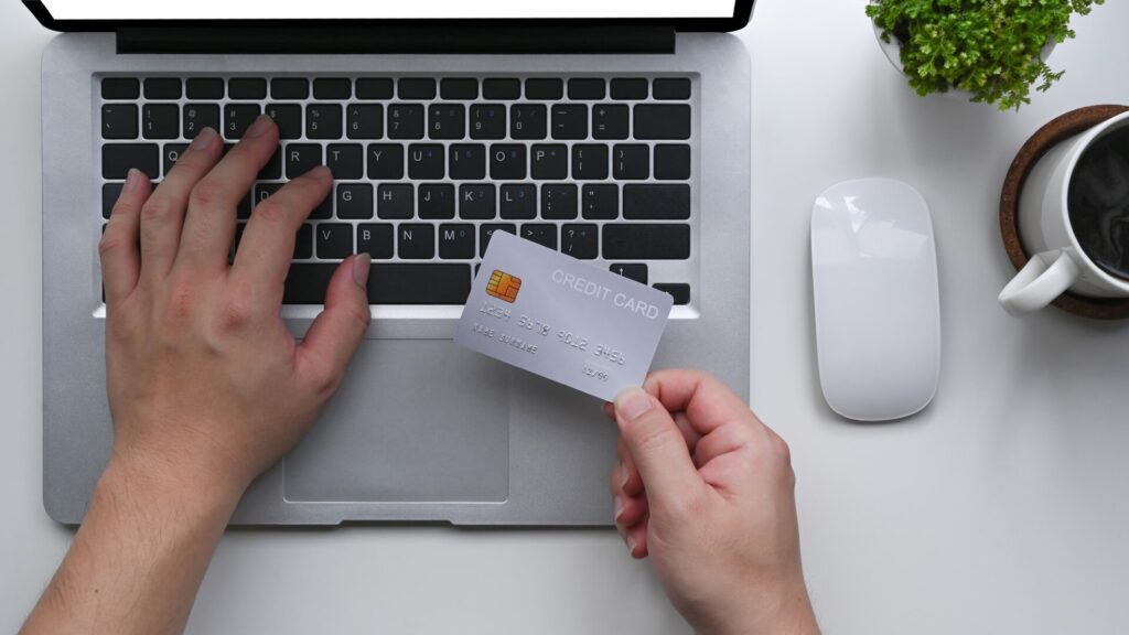 Person paying online with a credit card while buying tickets for a sporting event.