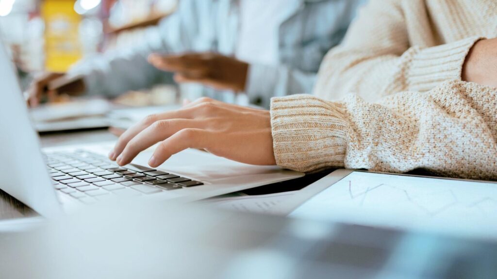 A person uses a laptop to manage online accounts and personal information, highlighting the importance of account security after a data breach.