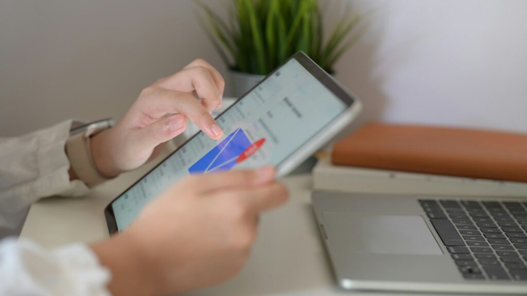Person reviewing email notifications on a tablet, illustrating steps users can take to protect their accounts after a reported data breach