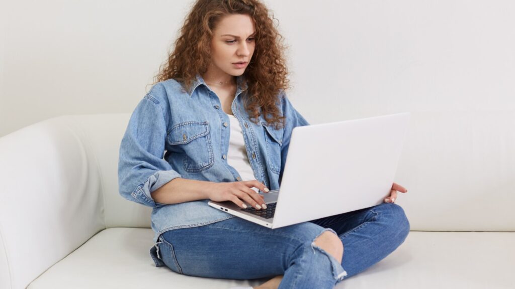 Woman using a laptop while reviewing browser settings and Chrome extensions for privacy risks.