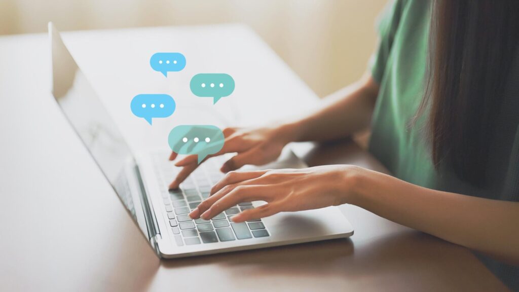 A person types on a laptop with message icons above the keyboard, representing phishing risks after the Nextcloud data leak.