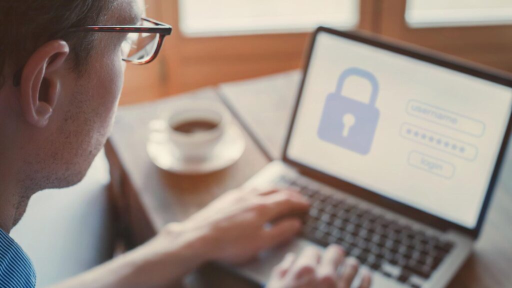 Man signs in securely on a laptop before reviewing sensitive online information.